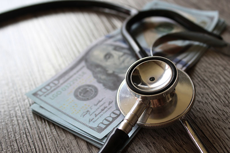 Photo of money and a stethoscope